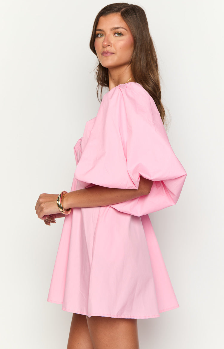 Side view of a pink mini dress showing the voluminous puff sleeves and A-line skirt