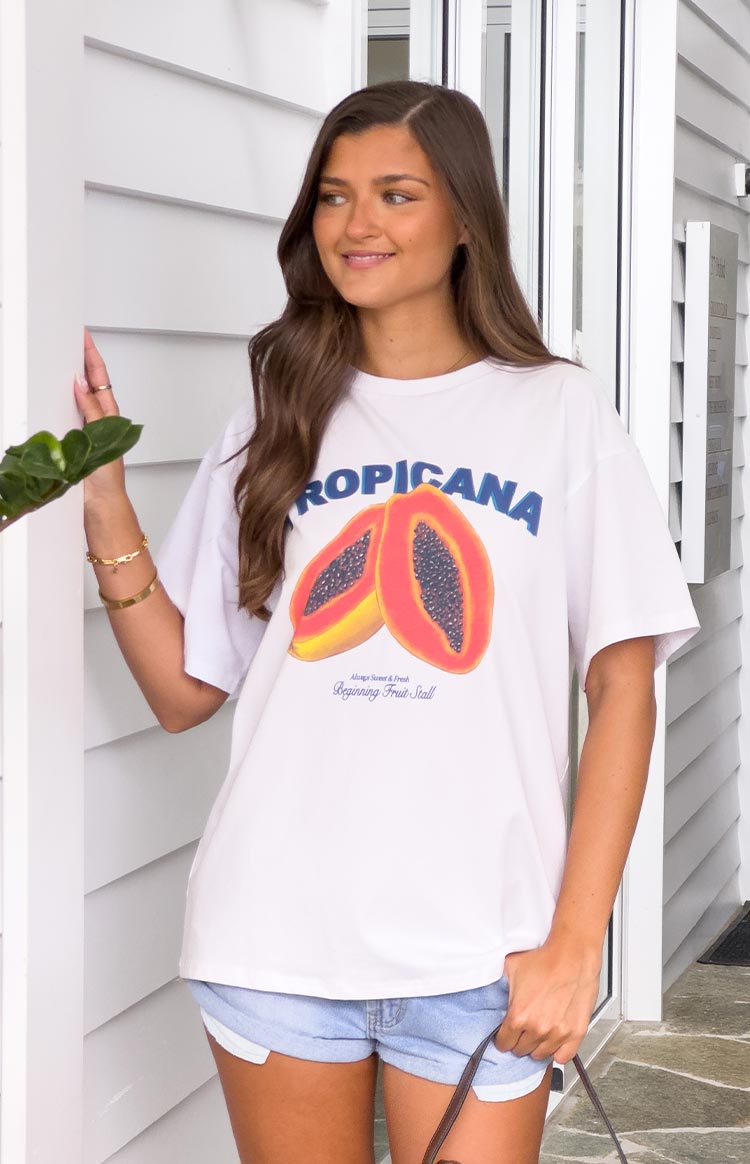 Front view of an oversized white tee with a blue TROPICANA graphic and two papaya halves