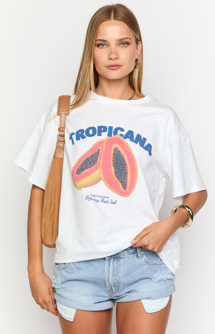 White oversized tee featuring a large 'Tropicana' graphic with two vibrant pink and yellow papaya halves and small text