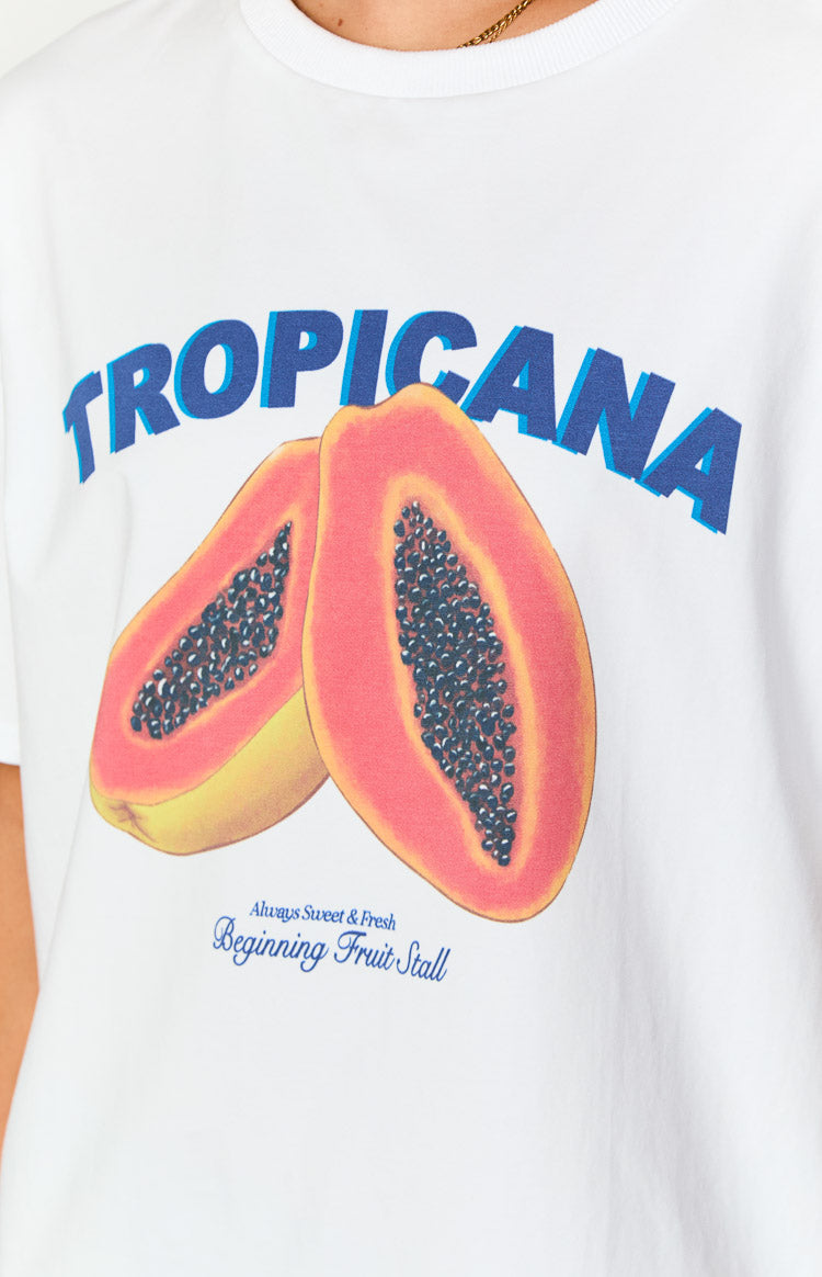 Close-up of the blue 'TROPICANA' graphic print with two papaya halves and 'Beginning Fruit Stall' text on a white tee