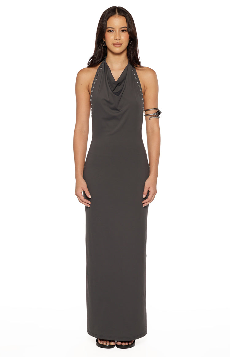 Front view of a grey bodycon maxi dress with a cowl neck and silver stud details along the halter straps