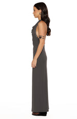 Side view of a grey cowl neck maxi dress with stud details along the armhole and a straight fit