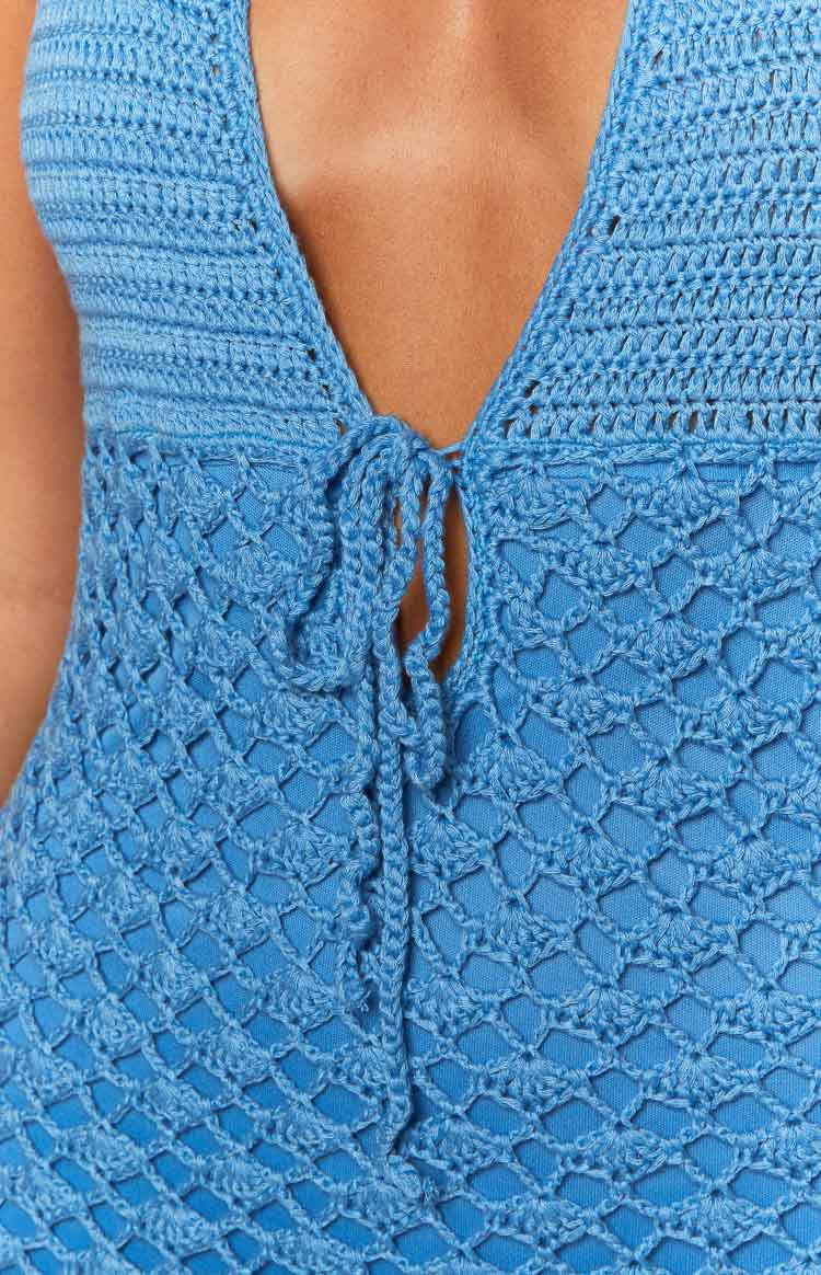 Close-up of the blue crochet mini dress with a tie-front closure and open-weave pattern