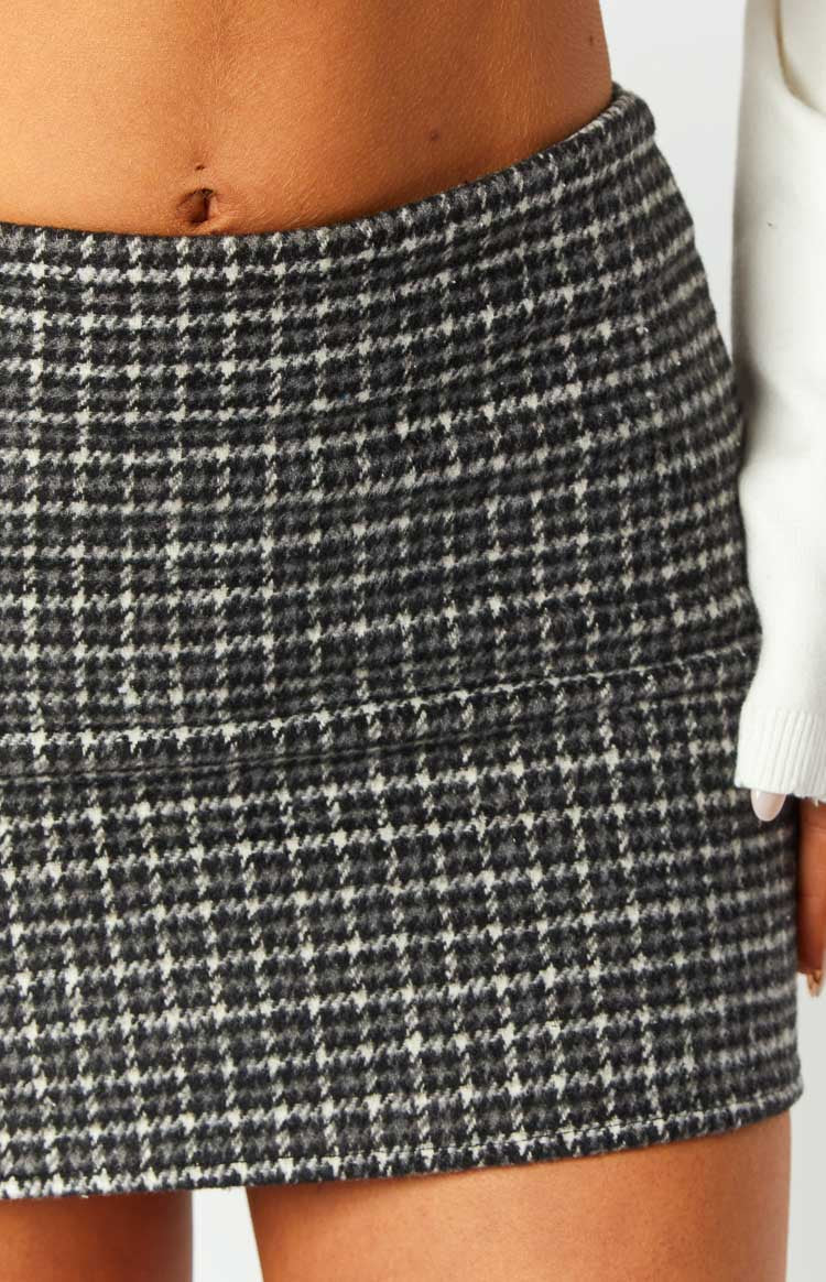 Close-up of the grey plaid mini skirt showing the textured fabric and a subtle horizontal seam detail