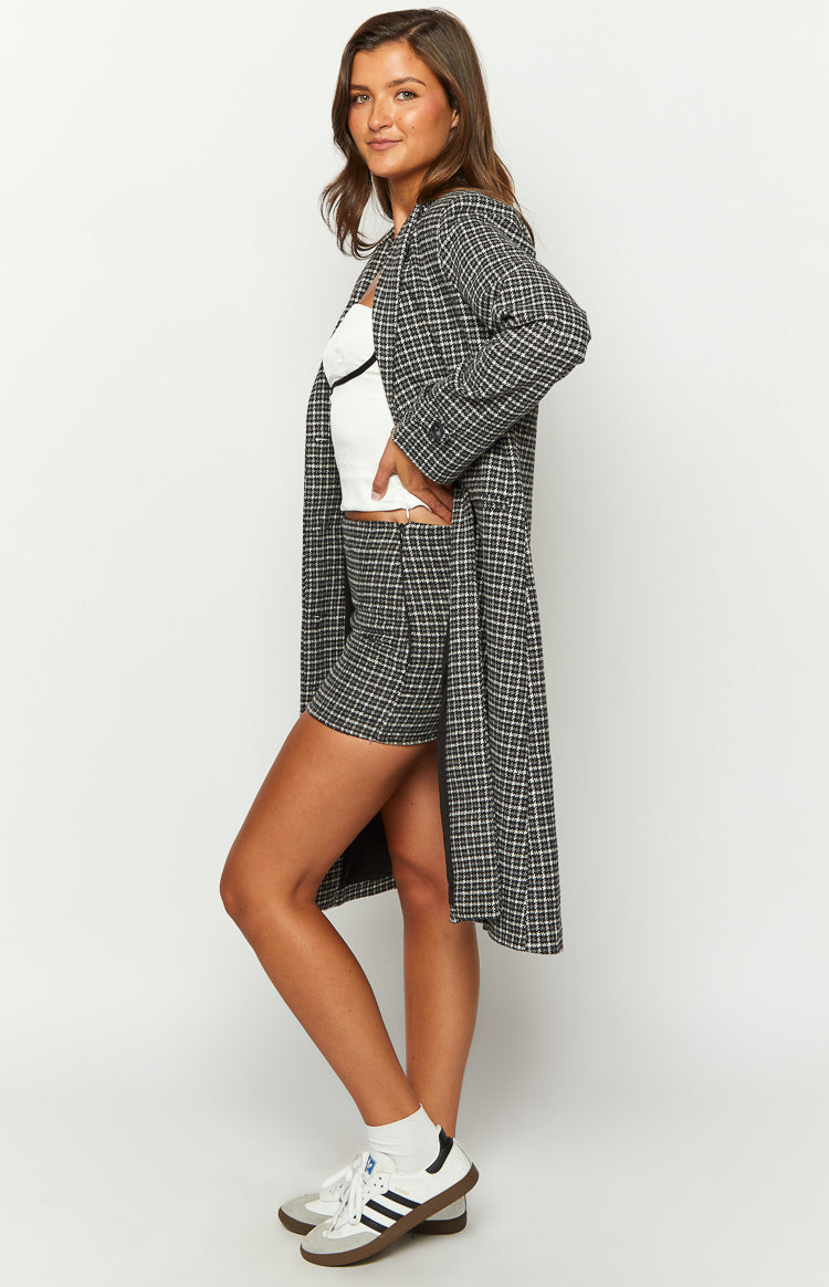 Side view of a grey plaid mini skirt, showing the short length and fitted silhouette