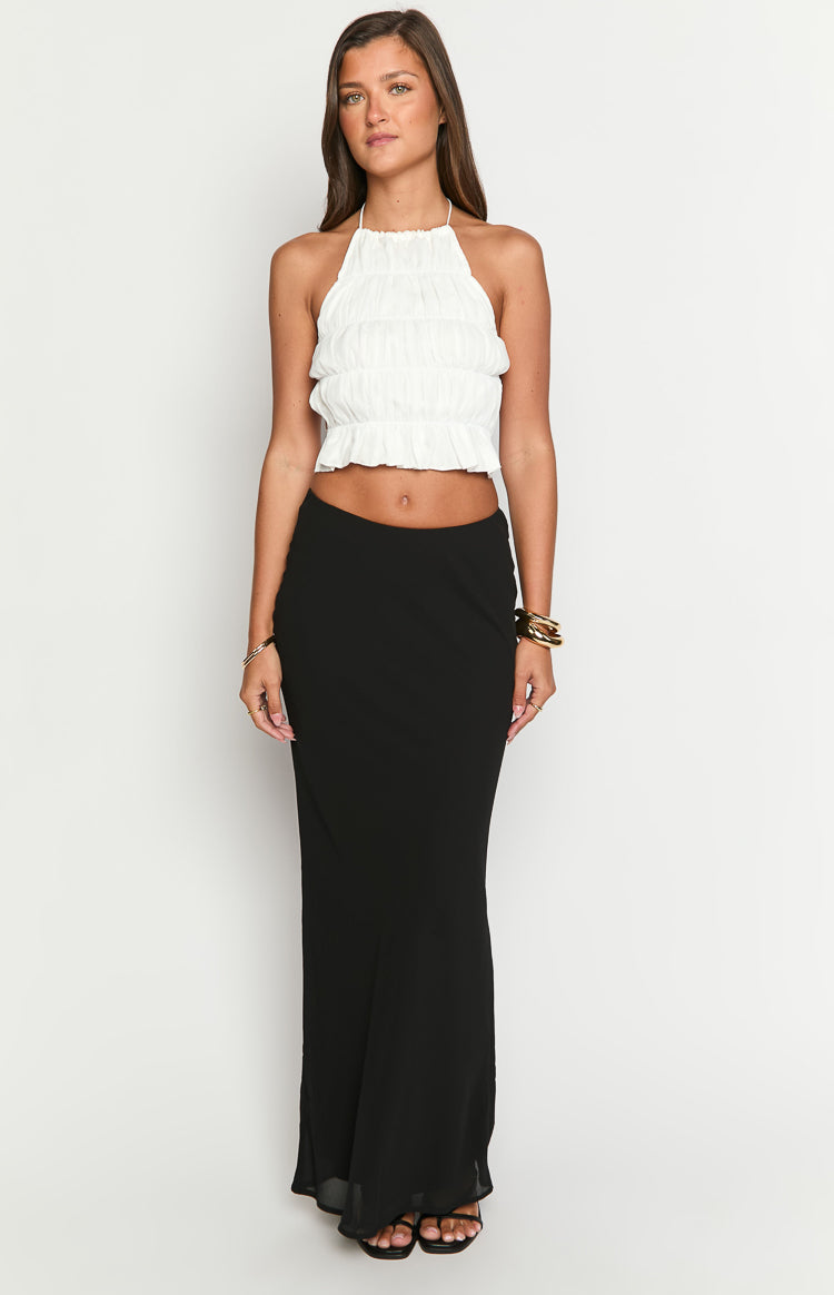 Front view of a white tiered ruched halter neck crop top with a ruffled hem