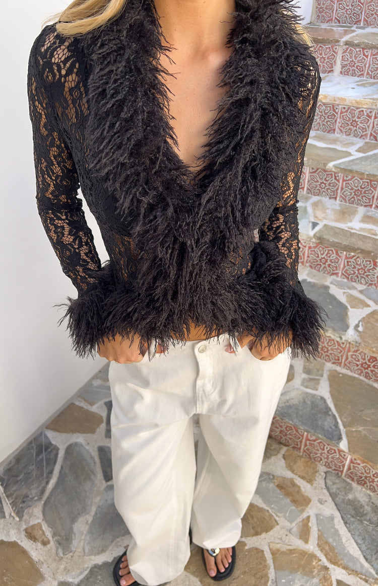 Black lace top with shaggy fur trim on the deep V-neckline, cuffs, and hem