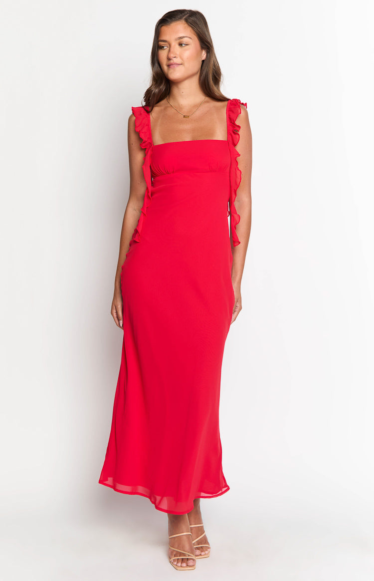 Red maxi dress with a square neckline, delicate ruffle shoulder straps, and a flowing skirt