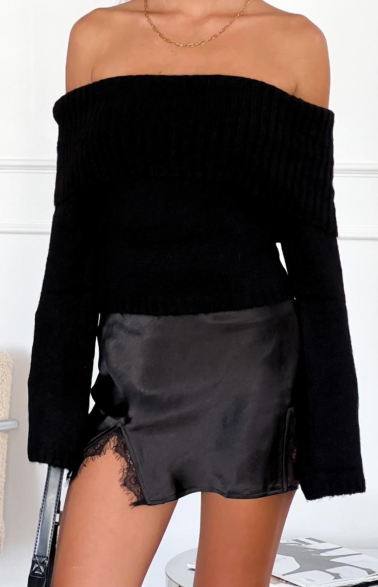 Black silky mini skirt with a side slit and black lace trim