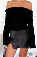 Black off-shoulder sweater with a wide ribbed fold-over neckline and long flared sleeves