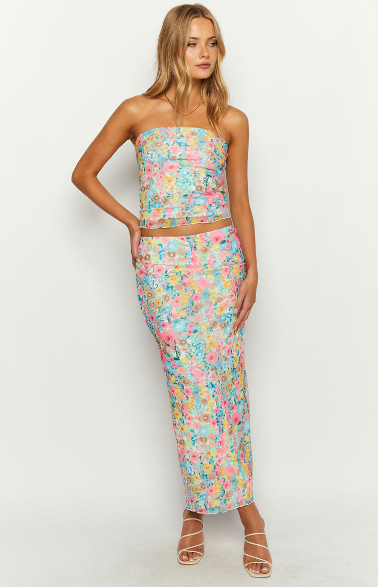 Full length view of a multi floral maxi skirt with a vibrant pastel pattern and fitted silhouette