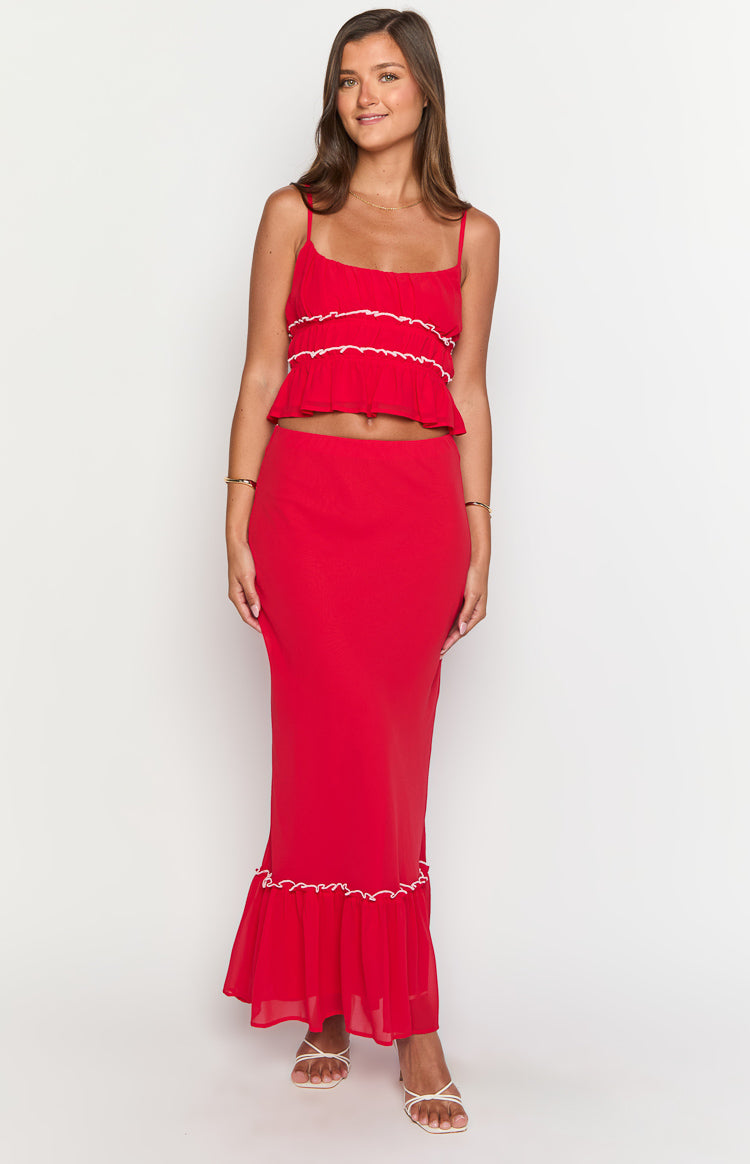 Red crop top with thin spaghetti straps, a straight neckline, and white ruffled trim details