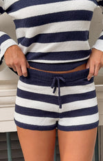 Close-up of navy and white striped knit shorts showing the ribbed elastic waistband and drawstring