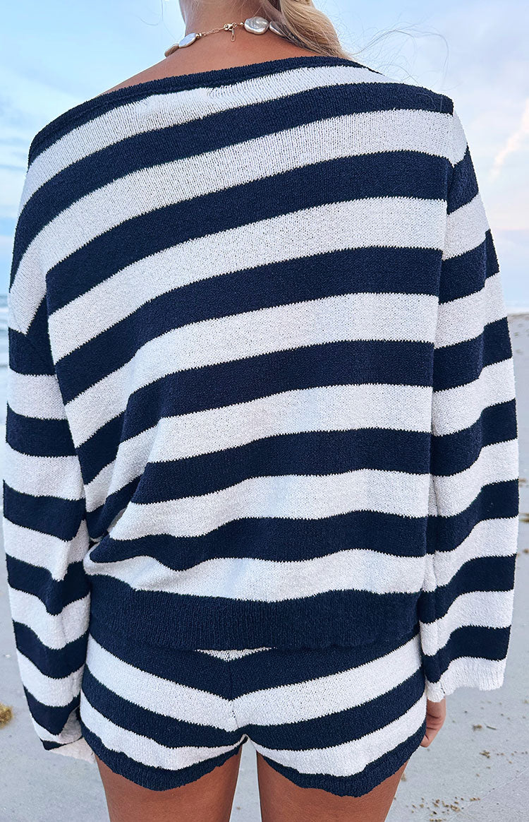 Rear view of the navy and white striped knit sweater, showing the wide boat neckline, long sleeves, and textured knit