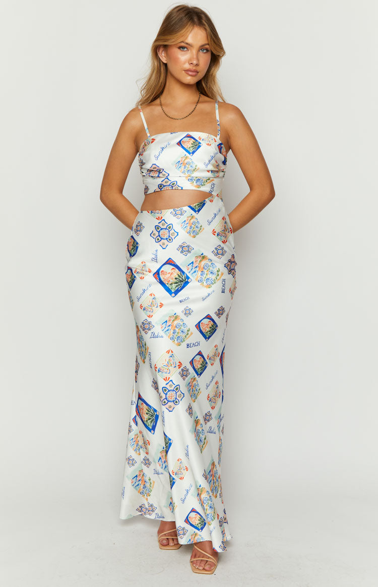 Front view of a white satin Italia print maxi dress with a square neckline, spaghetti straps, and waist cutouts