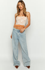 White floral lace tank top with a straight neckline, thin spaghetti straps, and orange contrast hem