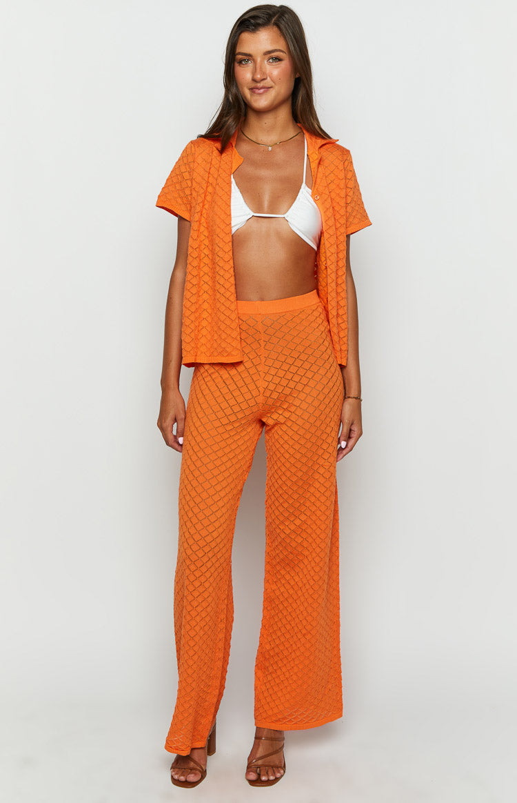 Front view of orange open knit wide-leg pants with a comfortable ribbed waistband