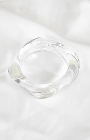 Thick clear resin bangle with a soft, wavy square shape
