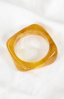 The Zantie Yellow Resin Square Bangle a vibrant accessory that adds a fun pop of colour to any summer outfit.