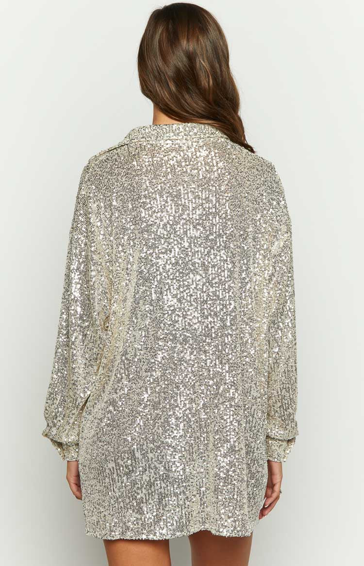 Rear view of the gold sequin long sleeve shirt, highlighting the relaxed fit and cuffed long sleeves