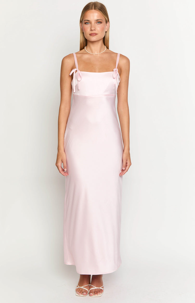 Flowy light pink satin maxi dress with a square neckline and thin shoulder straps tied into bows