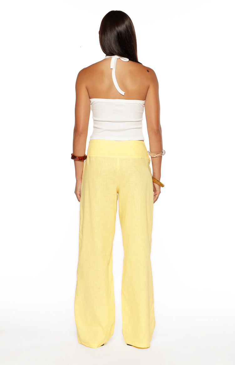 Rear view of yellow wide-leg pants with a wide high-waisted band and relaxed fit