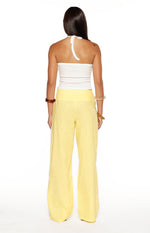 Rear view of yellow wide-leg pants with a wide high-waisted band and relaxed fit