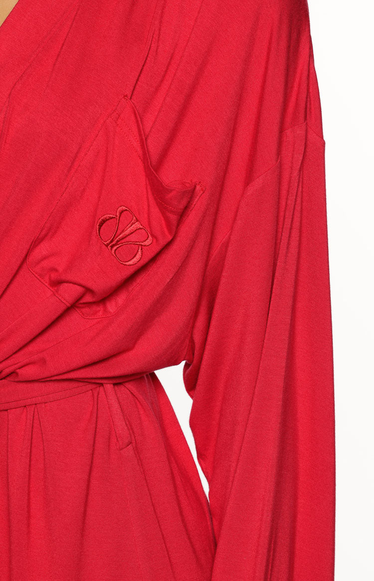 Close-up of the left chest pocket with an embroidered BB logo on a burgundy robe, showing the long sleeve