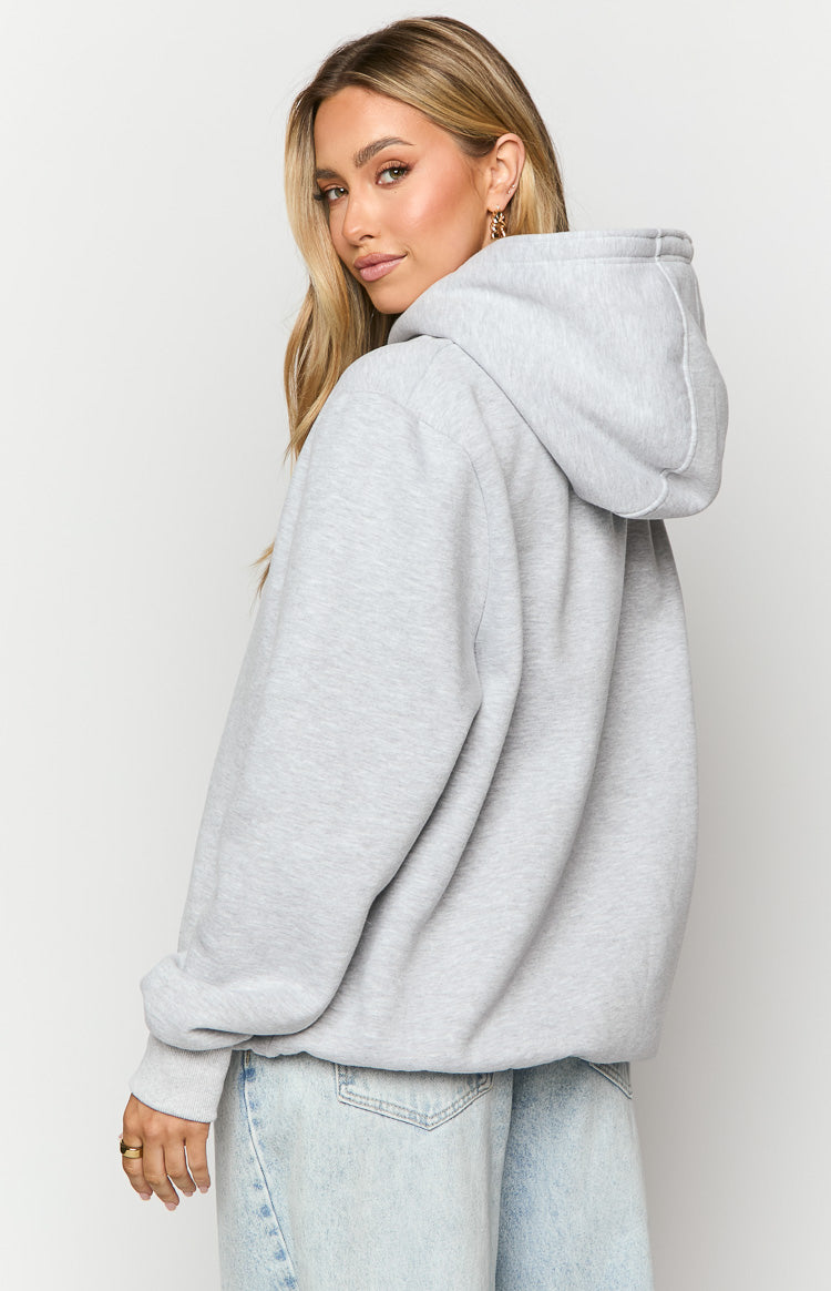 Side view of a grey marl oversized hoodie with a visible hood and ribbed cuffs, showing the bubble hem