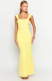 Front view of a yellow mesh maxi dress featuring a square neckline, ruched wide straps, and a flowing skirt