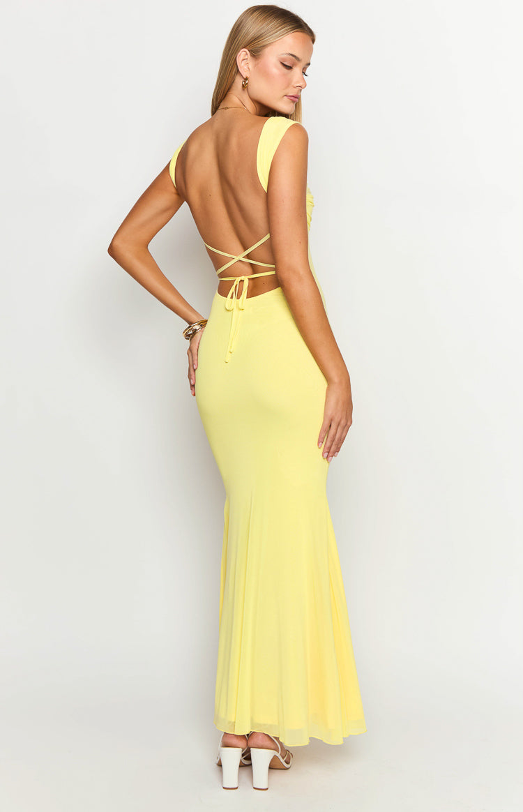 Rear view of a yellow mesh maxi dress with a low scoop back, criss-cross tie straps, and a flowing mesh skirt