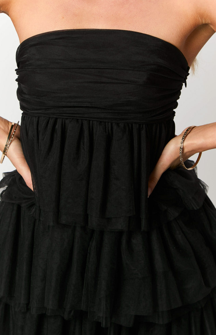 Close-up of the black strapless ruched bodice and tiered ruffled tulle mini dress