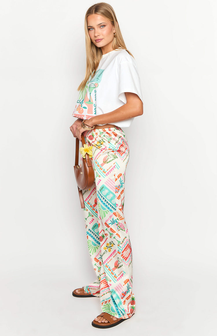 Side view of white wide-leg pants with a vibrant Dolce Vita print and relaxed fit