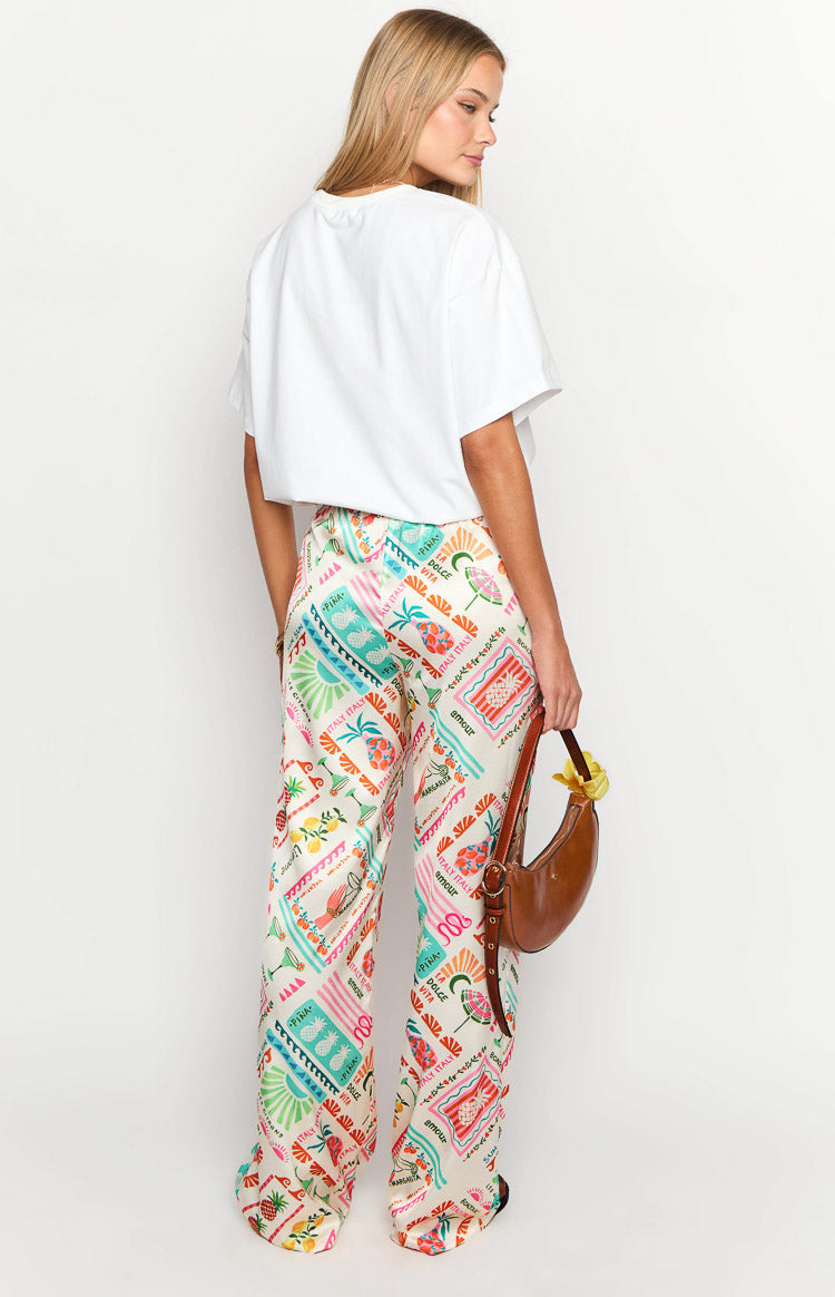 Rear view of cream wide-leg pants with a colourful Dolce Vita print and elasticated waist