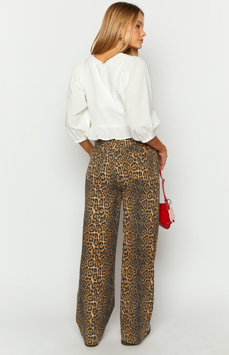 Rear view of brunet leopard print straight leg jeans, showing the back pockets and the full straight leg cut