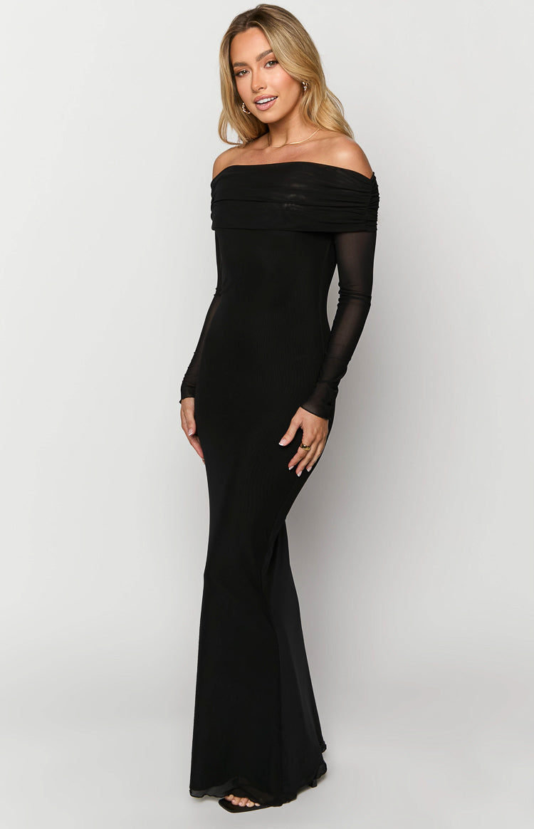 Side view of a black off-shoulder ribbed knit maxi dress with sheer long sleeves and a flared hem