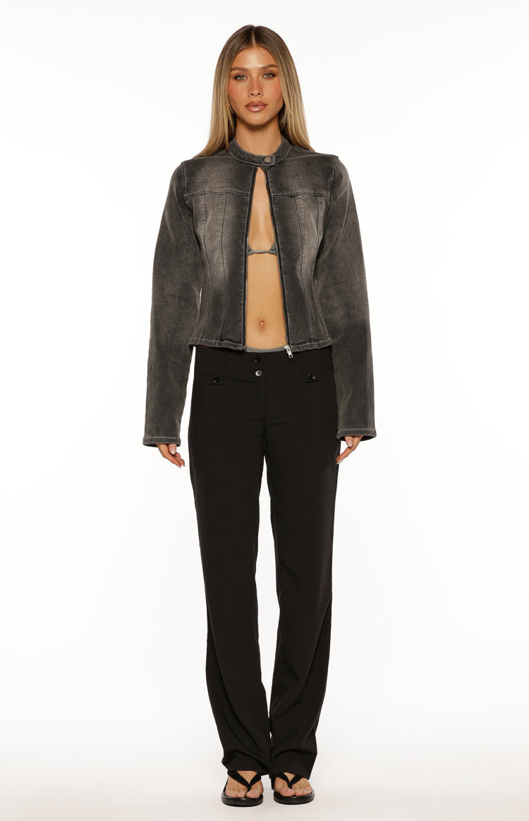 Front view of a cropped washed black denim biker jacket with a band collar and exposed zipper