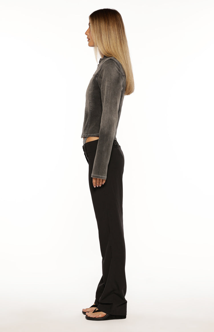 Side view of a black washed denim biker jacket with long sleeves and a fitted silhouette