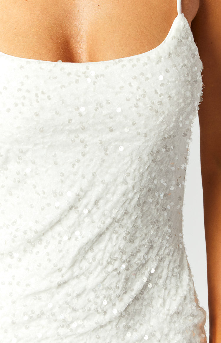 Close-up of the white sequin fabric with a subtle textured base and thin spaghetti strap