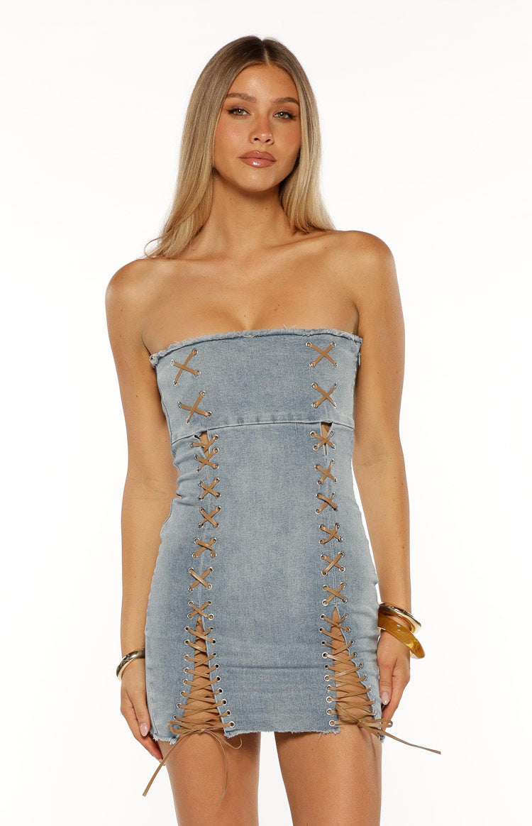 Light wash denim strapless mini dress with brown criss-cross lacing creating cutouts on the front and sides