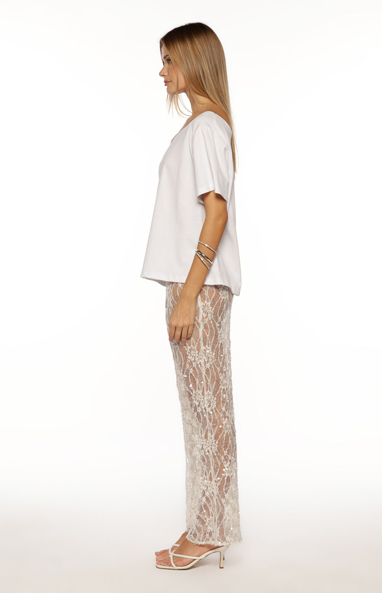 Side view of white sequin lace sheer pants with a straight leg fit