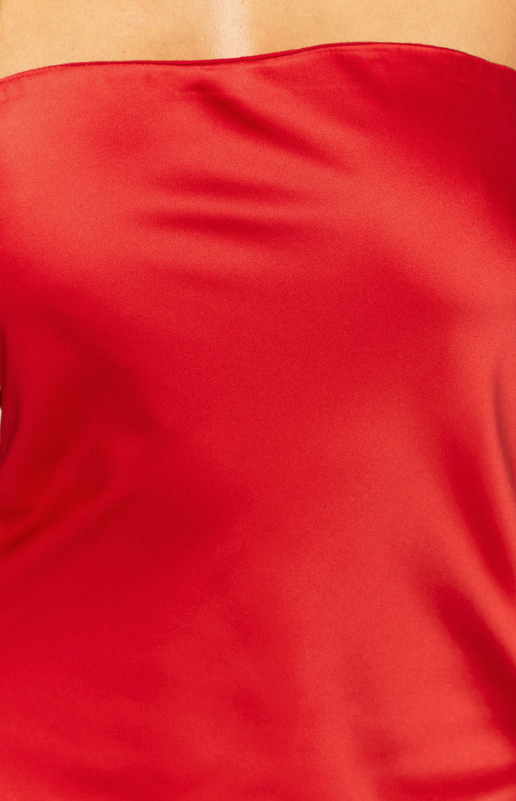 Close-up of the red satin fabric, showing the smooth texture and subtle sheen of the strapless neckline
