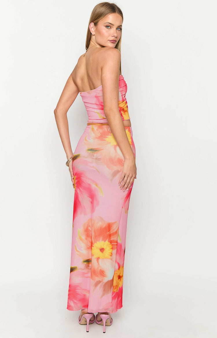Rear-side view of the pink floral maxi skirt with large orange and yellow flowers, showing its fitted silhouette
