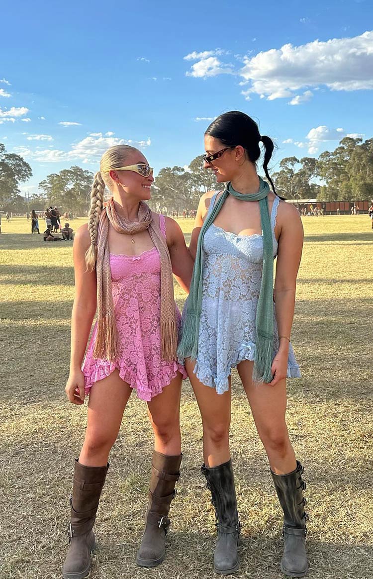 Front view of a pink floral lace mini dress with a sweetheart neckline, thin straps, and a ruffled hem