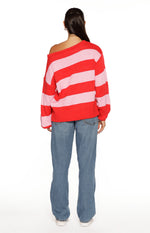 Rear view of a red and pink striped off-shoulder knit sweater with a relaxed fit