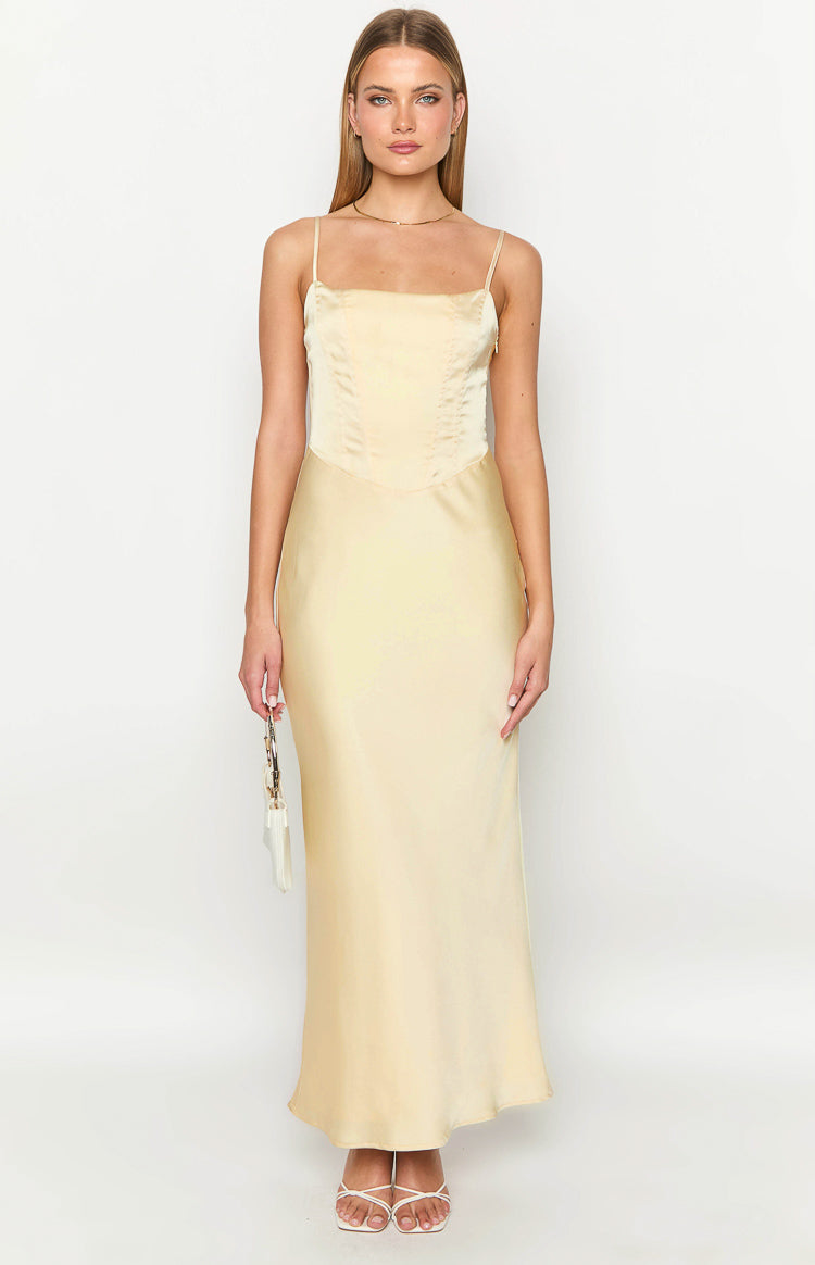 Front view of a pale yellow satin maxi dress with a square neckline and corset-style bodice