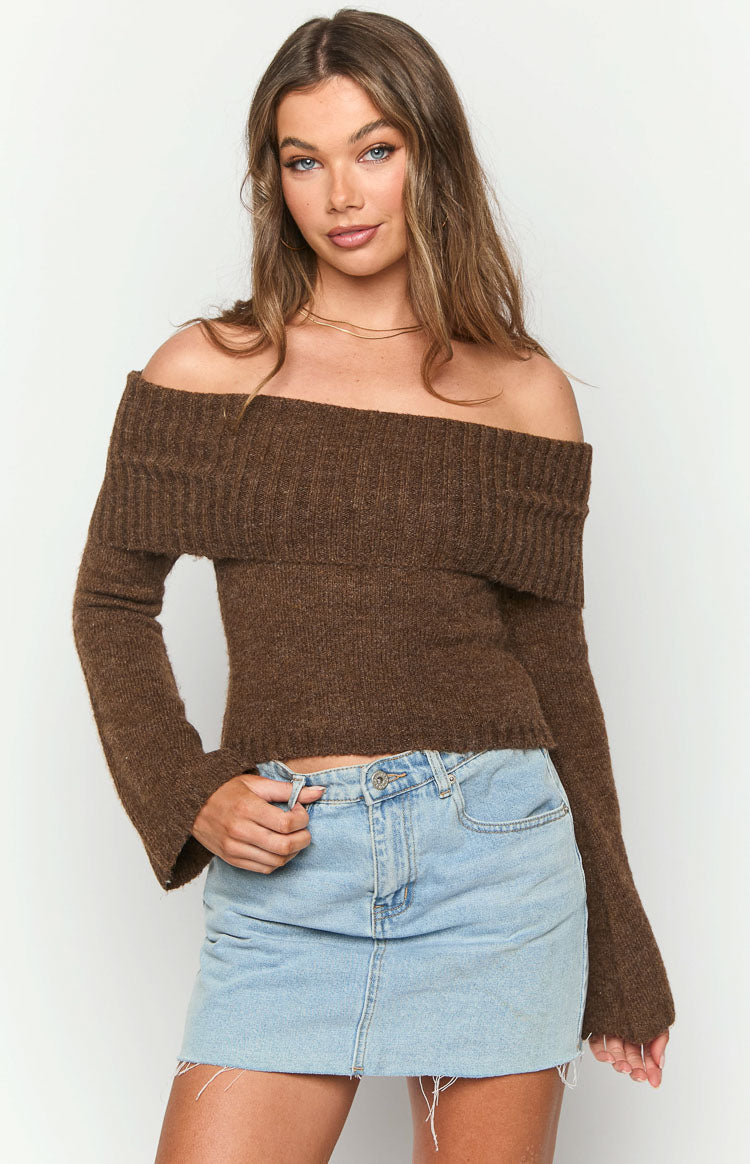 Brown off-shoulder knit sweater with a wide ribbed neckline, long sleeves with flared cuffs, and cropped fit