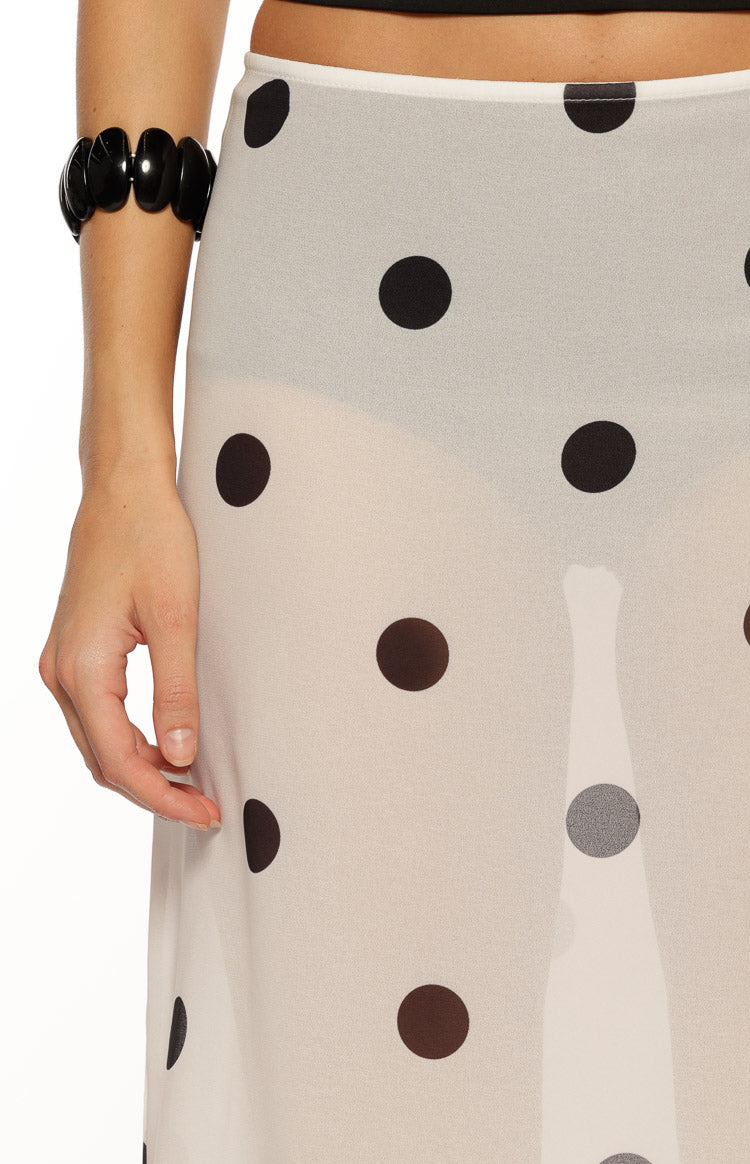 Close-up of the sheer white midi skirt with black polka dots and a visible waistband