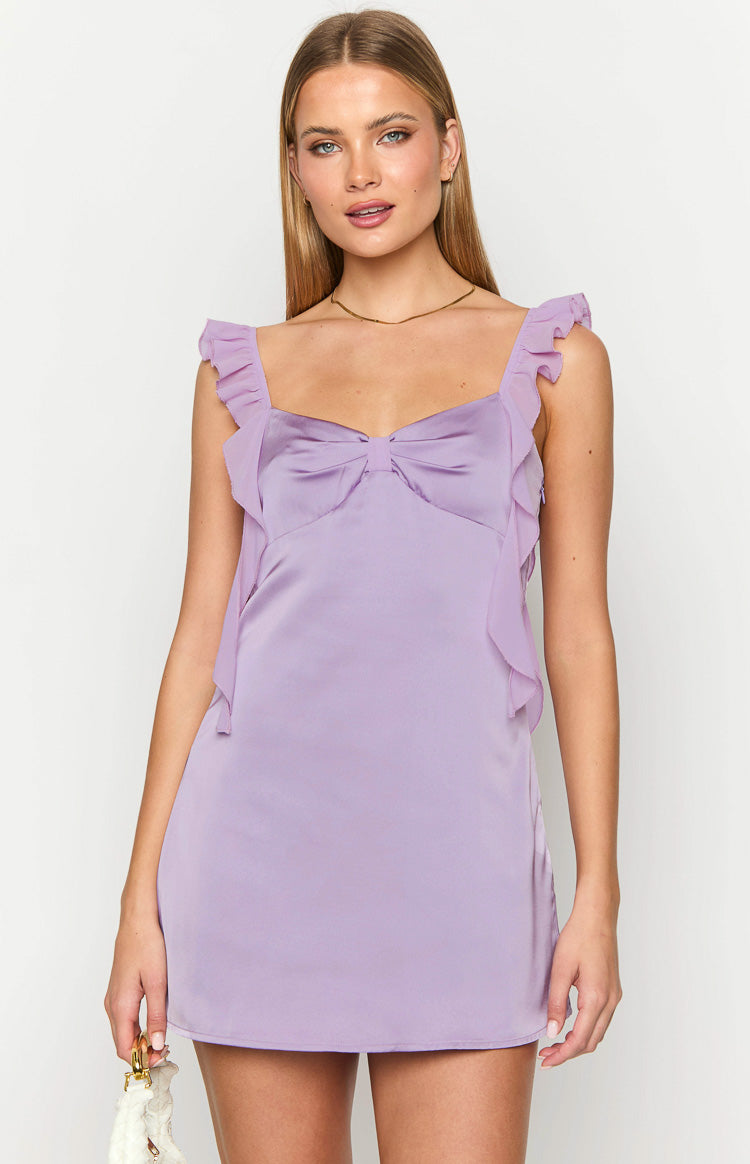 Lilac satin mini dress featuring a sweetheart neckline, a large bow detail on the bust, and ruffled straps