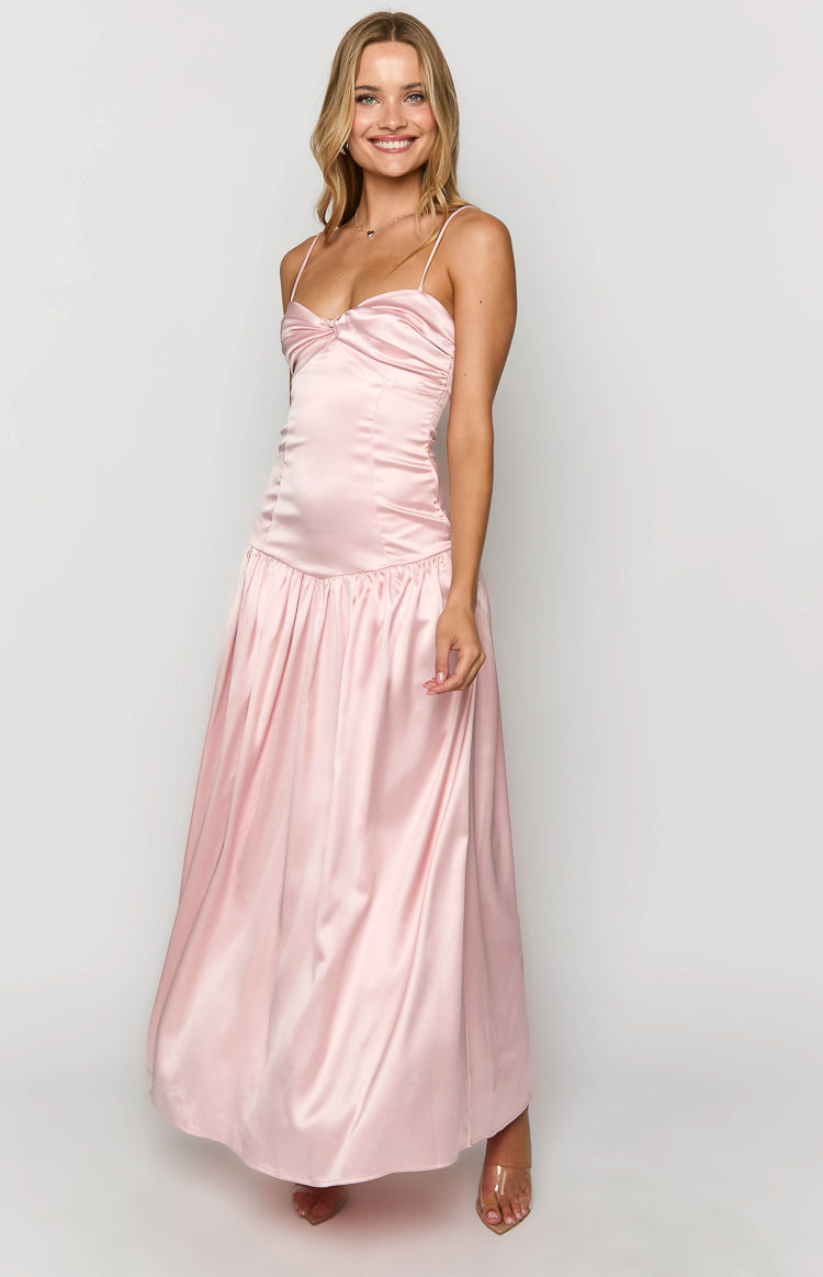 Front view of a pink satin maxi dress with a ruched bust, thin spaghetti straps, and a flowing skirt